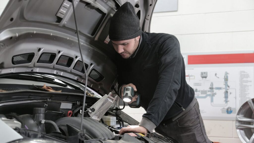 automotive technician checking vehicle for pre-purchase inspection