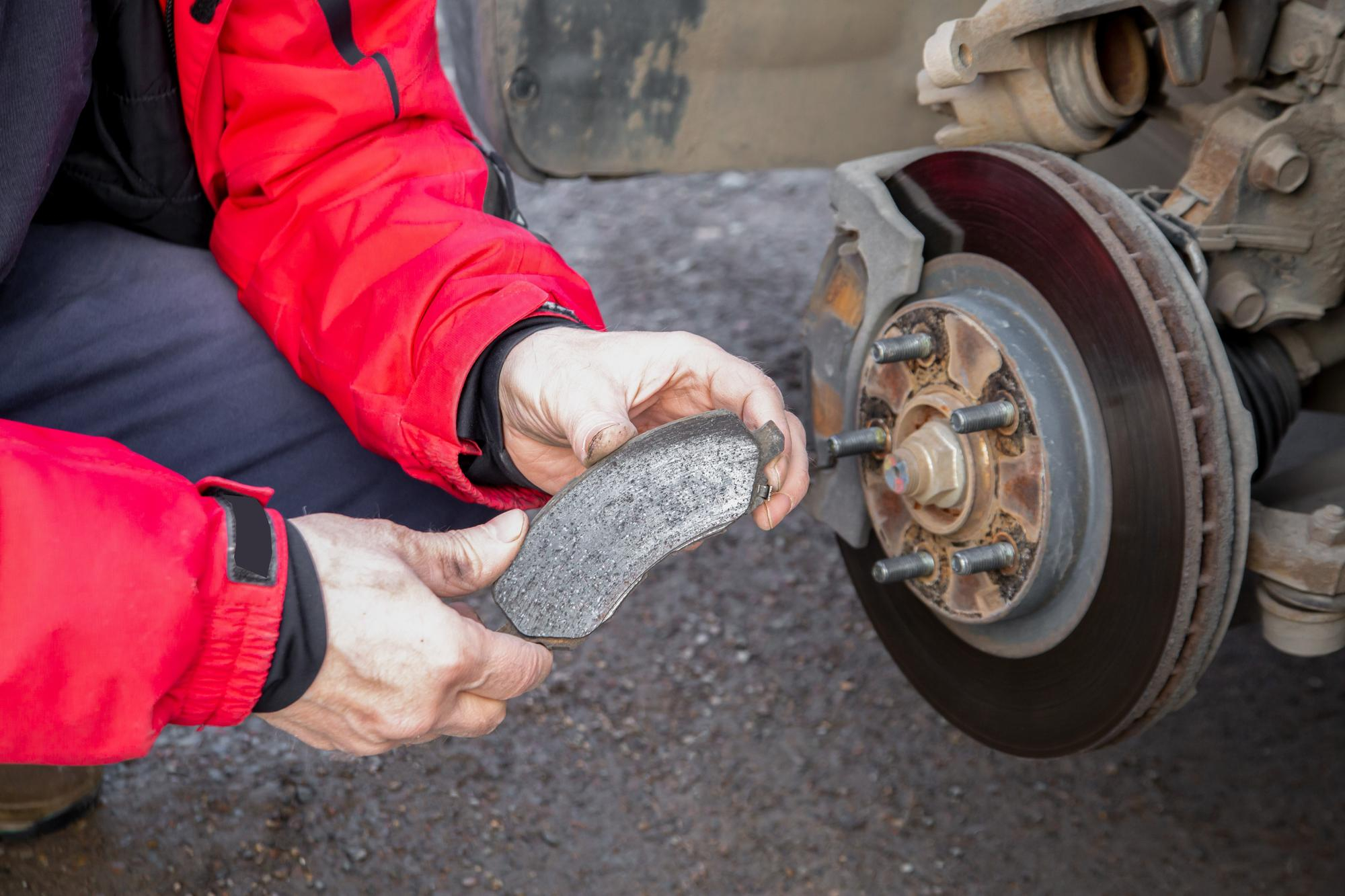 Mechanic conducting brake repair