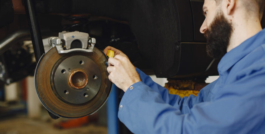 Mechanic overseeing brake repair
