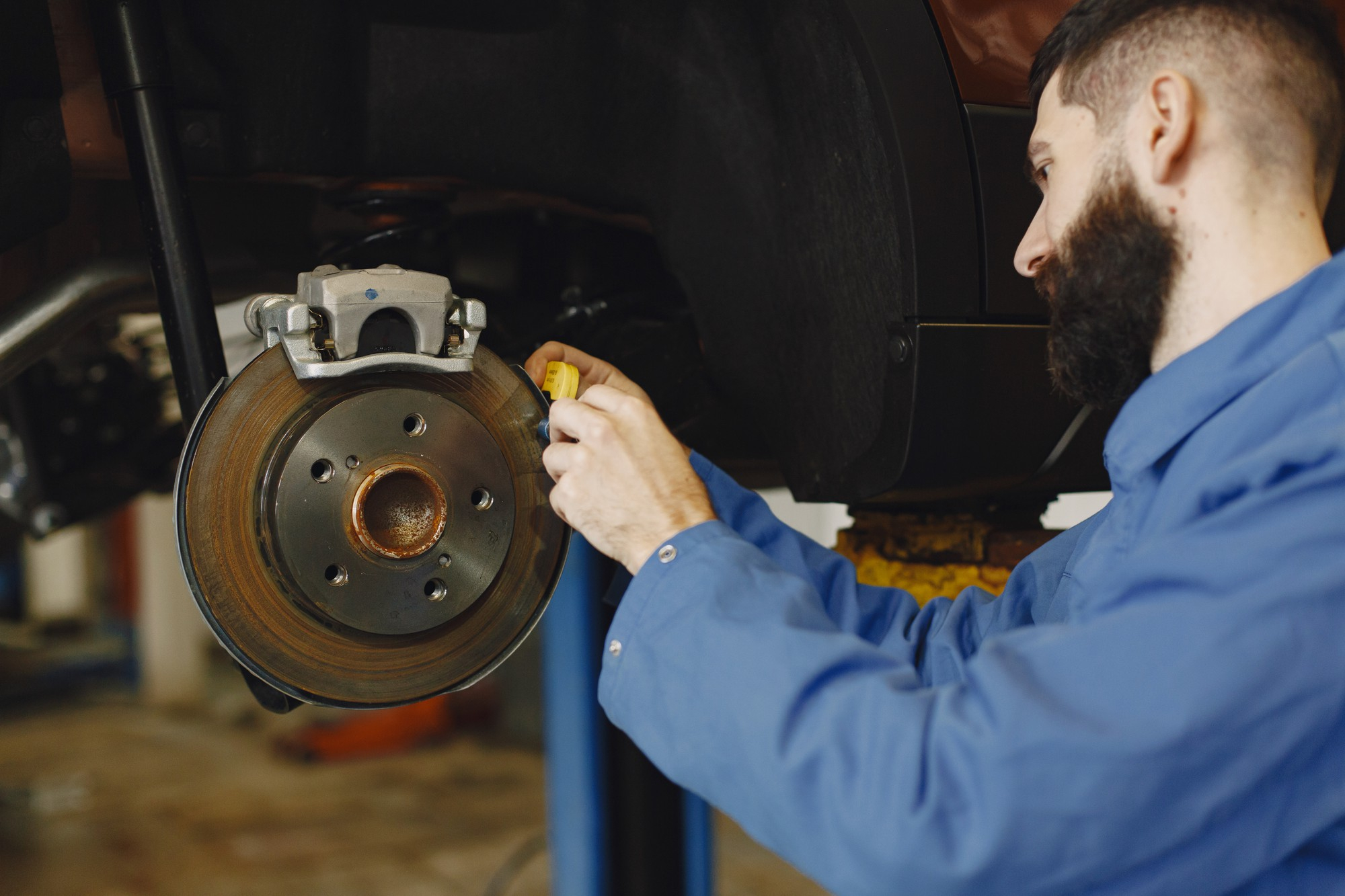 Mechanic overseeing brake repair