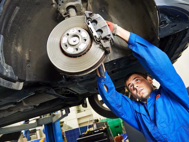 mechanic-inspecting-repairing-car-brake-system_573563-12469